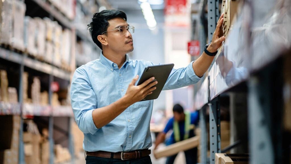 A man reviews inventory that was financed with short-term financing to fill a demand gap.