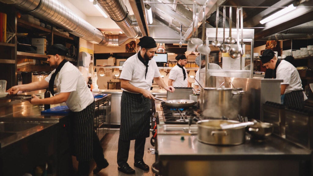 Cooks working in a restaurant kitchen.