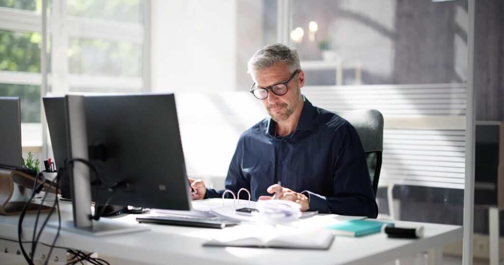 Man reviewing accounts receivable documents to explore financing options