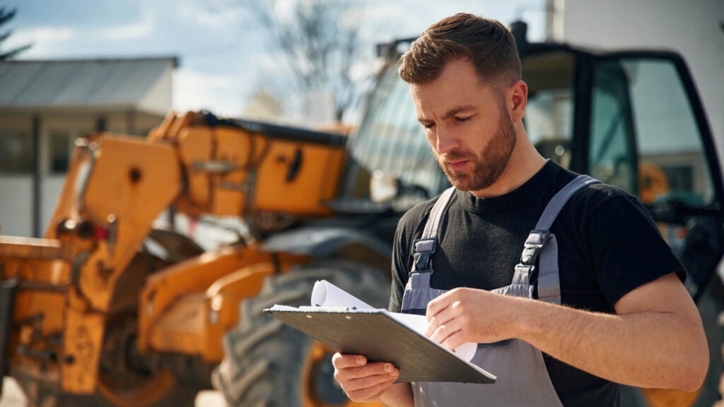 A small business owner goes over terms for financing equipment.